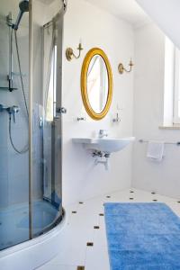 a bathroom with a shower and a sink and a mirror at Villa Park in Bukowina Tatrzańska +22 photos