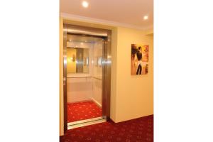 a hallway with a glass door to a walk in shower at Hotel Post in Scheidegg