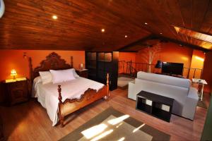 a bedroom with a bed and a flat screen tv at Casa Campelo in Cedeira