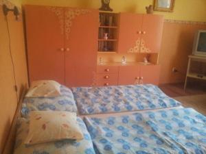 a bedroom with two beds and a dresser at Marcsi Apartman in Gyula