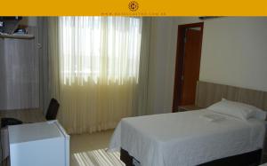 Cama ou camas em um quarto em Hotel Castro