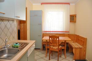 a kitchen with a table and a dining room at Pension "AM RENNSTEIG" in Eisenach