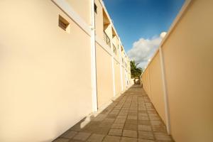 an empty alley with a blue sky in the background at Regal Apartments in Kololi