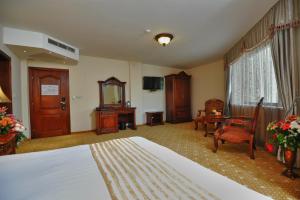 a living room filled with furniture and a fireplace at Park Hotel Stara Zagora in Stara Zagora