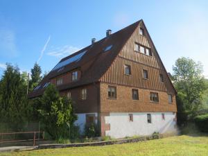 a large house with solar panels on the roof at Ferienwohnung del Arte in Baiersbronn