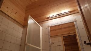 a bathroom with a shower and a wooden ceiling at Duplex à la Moutière in Tignes +22 photos