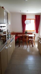 a kitchen with a table and a dining room at Ferienwohnung del Arte in Baiersbronn +7 photos