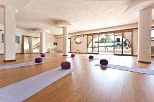 a large room with yoga mats on the floor at Hotel Kalura in Cefalù