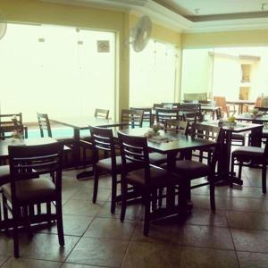 a dining room with tables and chairs in a restaurant at Pousada Hippocampus in Juquei