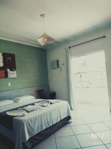 a bedroom with two beds and a window at Pousada Hippocampus in Juquei +8 photos