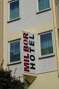 a sign on the side of a building with windows at Milbor Hotel in Bad Soden am Taunus