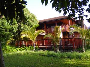 a resort building with trees in front of it at Monzi Safari Lodge in St Lucia