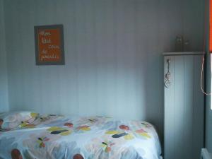 a bedroom with a bed and a sign on the wall at La Halte 1C in Villeret