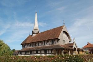 a large church with a steeple on top of it at La Halte 1C in Villeret