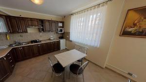 a kitchen with a table and chairs in it at Villa Aida in Mielno