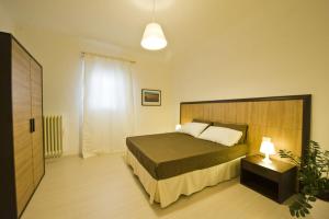 a bedroom with a bed and a night stand with a lamp at Vico Amato Residenza in Sulmona