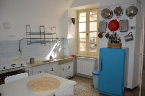 a kitchen with a blue refrigerator in a room at La Casa Torre di Eva in Sarzana +17 photos