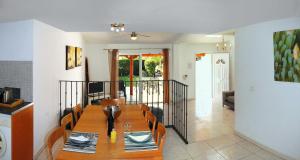 a dining room with a wooden table and chairs at Casa Miguel in San Miguel de Abona