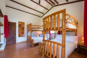 a bedroom with two bunk beds in a room at Istmo Beach and Jungle Bungalows in San Carlos
