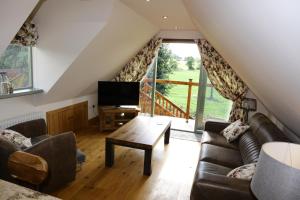 a living room with a couch and a table at Thonock lane lodge in Gainsborough