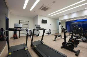 a gym with treadmills and ellipticals in a room at Go Inn Catalão in Catalão