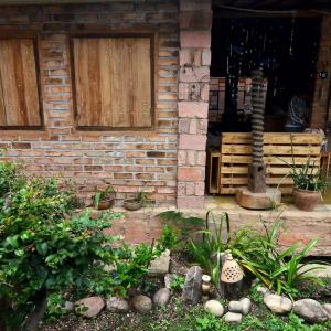 a brick house with a garden in front of it at hostelvi guesthouse in Lençóis +14 photos
