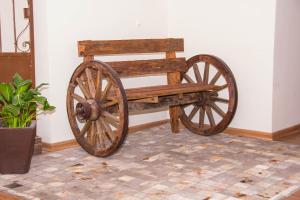 a wooden bench sitting on top of a floor at Dalle Hotel in Bagé