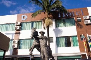 a statue of a man with a horse in front of a hotel at Dalle Hotel in Bagé