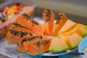 a plate of food with fruit on a table at Dalle Hotel in Bagé