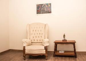 a chair sitting in a room with a table at Dalle Hotel in Bagé