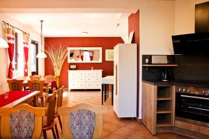 a kitchen and dining room with a white refrigerator at Pension & Ferienwohnung Oberhof 810 M in Oberhof
