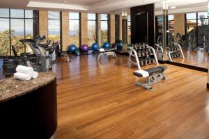 a gym with treadmills and exercise equipment on a wooden floor at Zimbali Suite 521 in Ballito