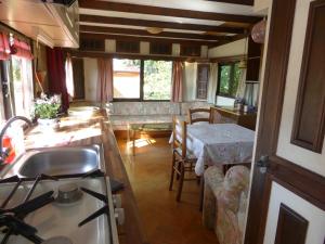 cocina y sala de estar con fregadero y mesa en Domaine Le Bois de l'Espaud, en Tronget