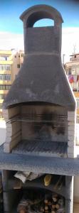 an outdoor oven with a bunch of food inside at Il prato sul terrazzo in Cagliari