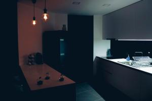 a kitchen with black cabinets and a counter top at Horizon View Madeira in Caniço +7 photos