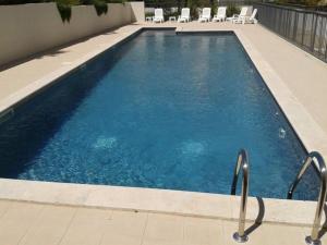 a large swimming pool with chairs in a building at Alpilles Villa Serena in Saint-Rémy-de-Provence