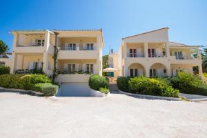 a house on the beach with bushes in front of it at Villa Muses in Poros