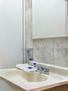 uma casa de banho com um lavatório, um espelho e um lavatório. em Hotel Sierra de Alica em Tepic