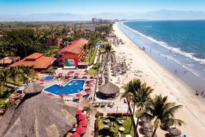 a view of a beach with umbrellas and the ocean at Royal Decameron Complex - All Inclusive in Bucerías