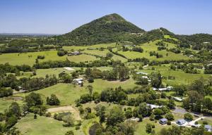an aerial view of a green field with a mountain at Eumundi Cottages - Cottage 2 in Eumundi