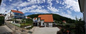 a house with an orange roof on a hill at Namhae Neuhaus in Namhae