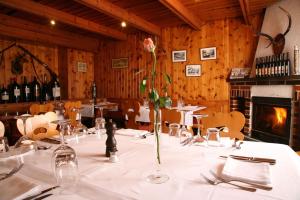 a table with a vase with a flower on it at Ristorante Groven in Lostallo