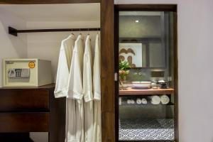 a kitchen with a door with a curtain and a microwave at Golden Temple Villa in Siem Reap
