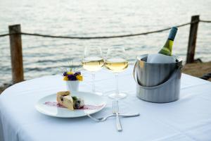 a table with a plate of food and wine glasses at Bluefin Bay on Lake Superior in Tofte