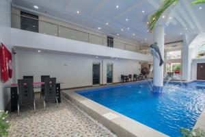 a large swimming pool with a dolphin in the middle of a building at IL Mare Sakura Resort Boracay in Boracay