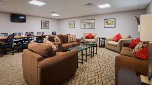 a waiting room with couches and a table and chairs at Best Western Plus Concordville Hotel in Concordville