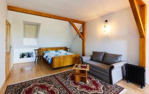 a living room with a bed and a couch at Nad Vinnym Sklipkem in Znojmo +30 photos