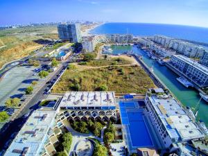 an aerial view of a city with a river and buildings at Israel Marina Village, Garden Vacation Apartment in Herzelia 