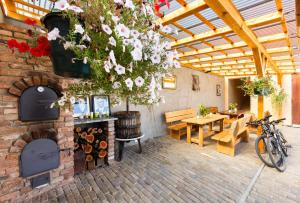 a patio with a brick wall with a table and a bike at Nad Vinnym Sklipkem in Znojmo