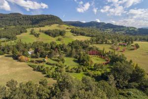 an aerial view of a house on a hill with trees at Crystal Creek Meadows in Kangaroo Valley